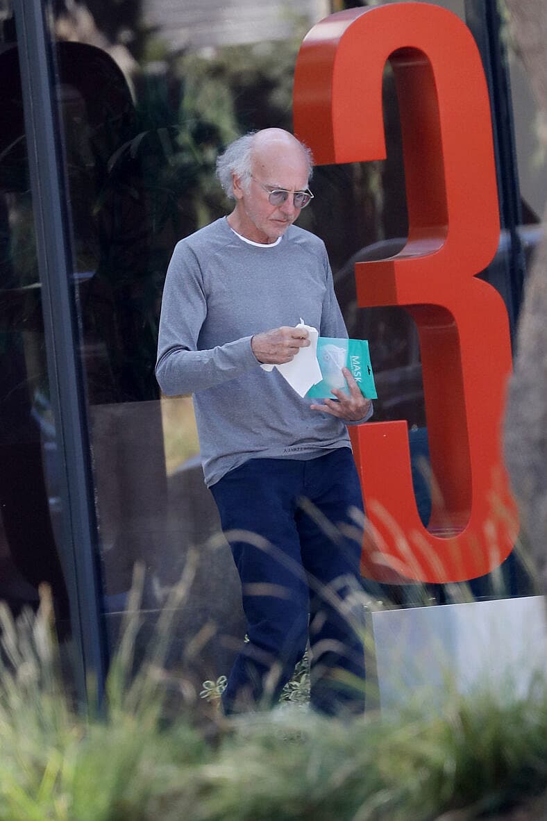 Newly wed Larry David coming out of an office building