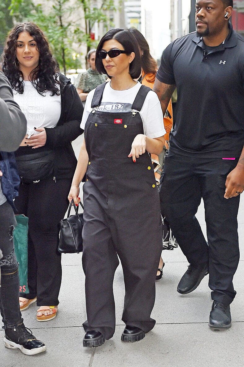 Kourtney Kardashian heads out in a Blink-182 t-shirt and overalls