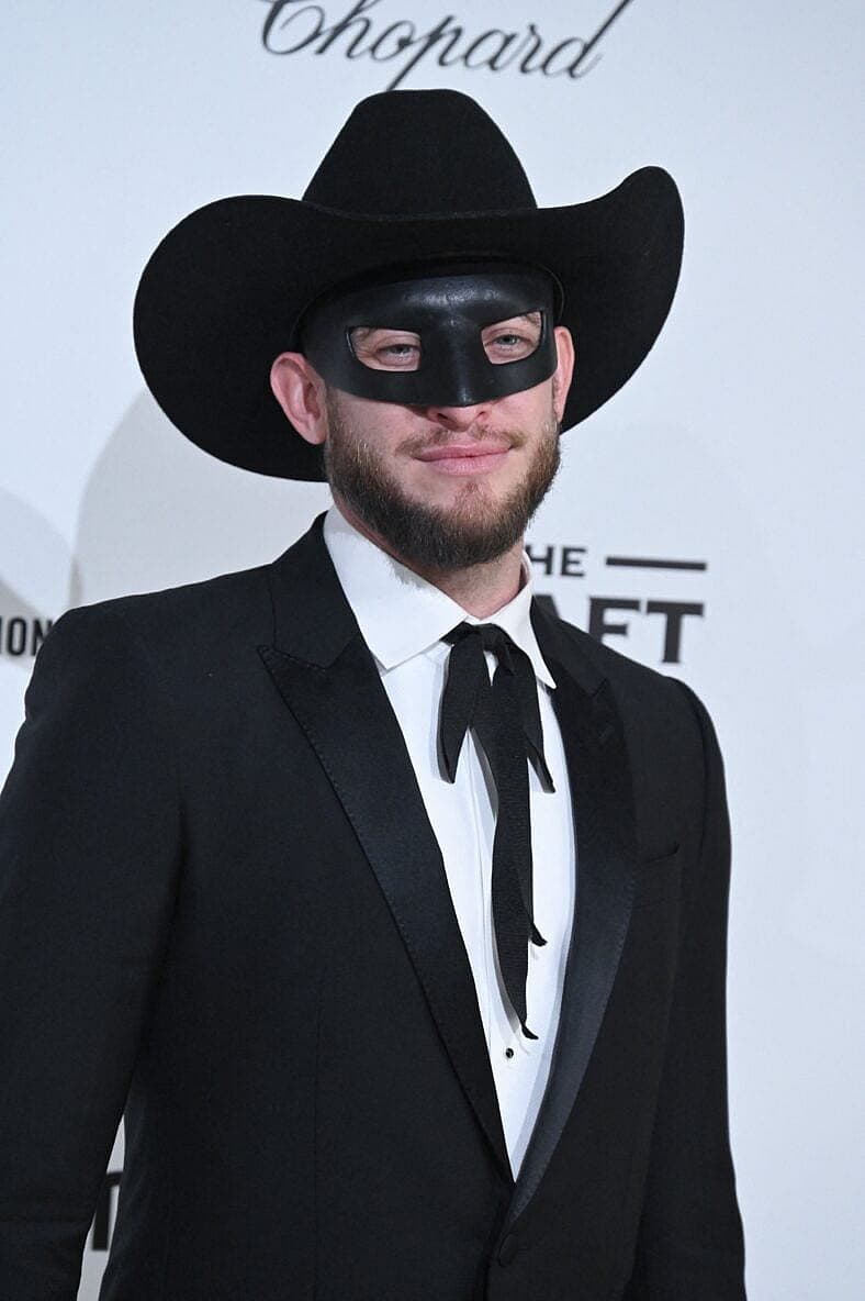 Orville Peck posing on the red carpet. 