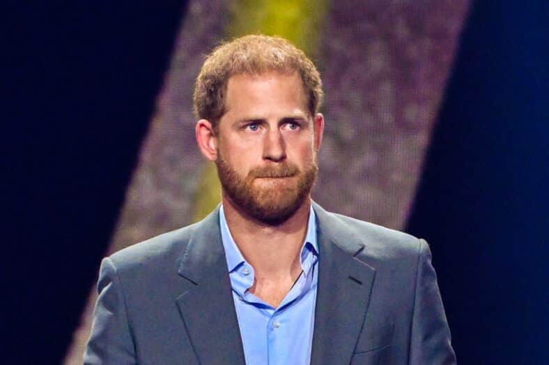 Prince Harry looks on from stage