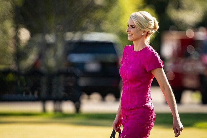 Natalie Harp in pink executive assistant to US President Donald Trump, walks behind President Donald Trump to Marine One on the South Lawn of the White House