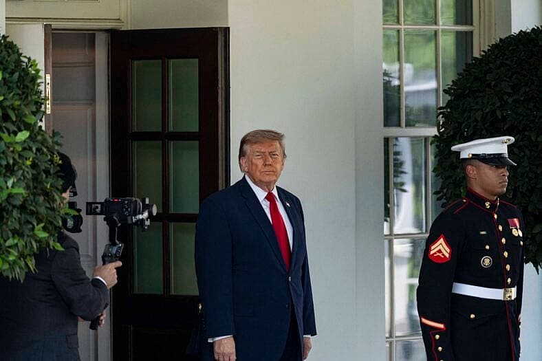 Donald Trump waits outside the White House