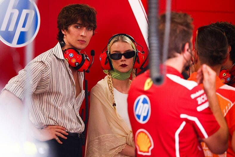 Anya Taylor-Joy and Malcolm McRae are seen in the Scuderia Ferrari garage during qualifying ahead of the Formula 1 Hungarian Grand Prix