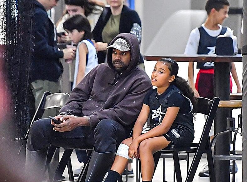 Kanye West and daughter North West sitting court side