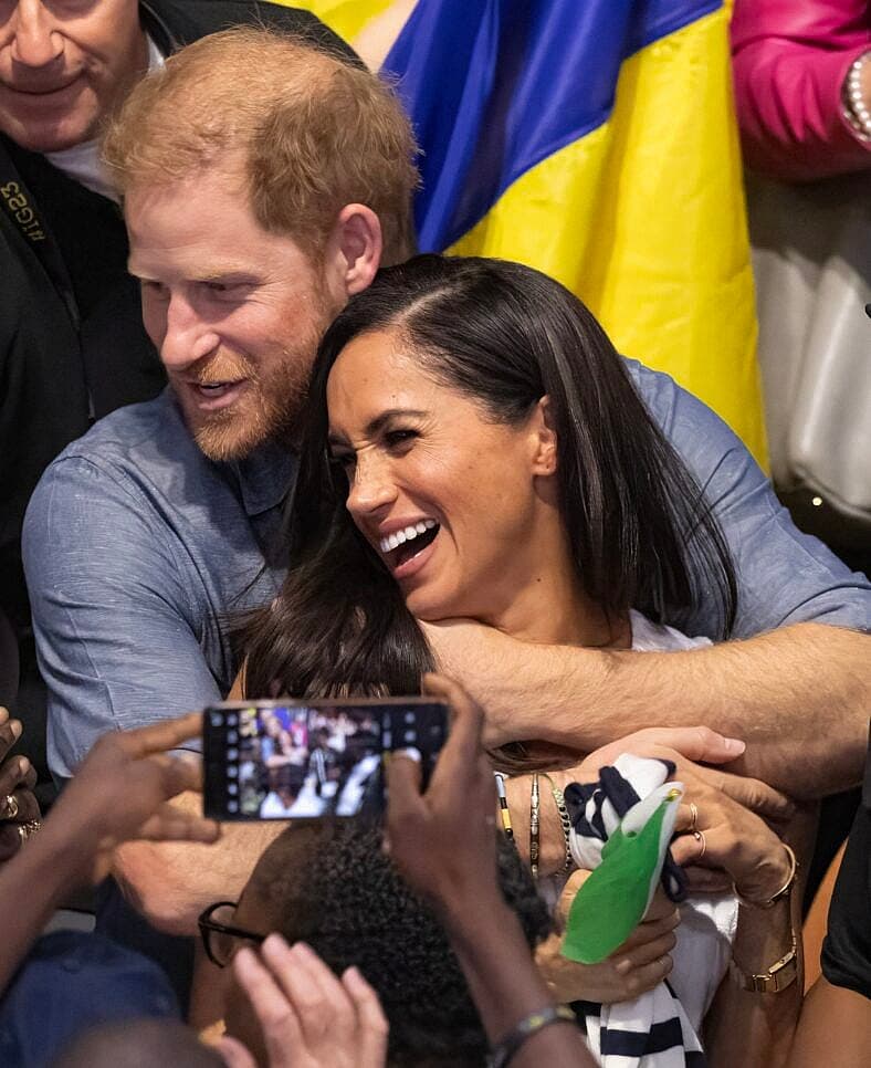 Prince Harry And Meghan Markle’s Big Megxit Reverse Reportedly Has A Guardian Angel 2 Prince Harry and Meghan Markle watch the Ukraine vs Nigeria Seated Volleyball, on day five of the Invictus Games Dusseldorf 2023