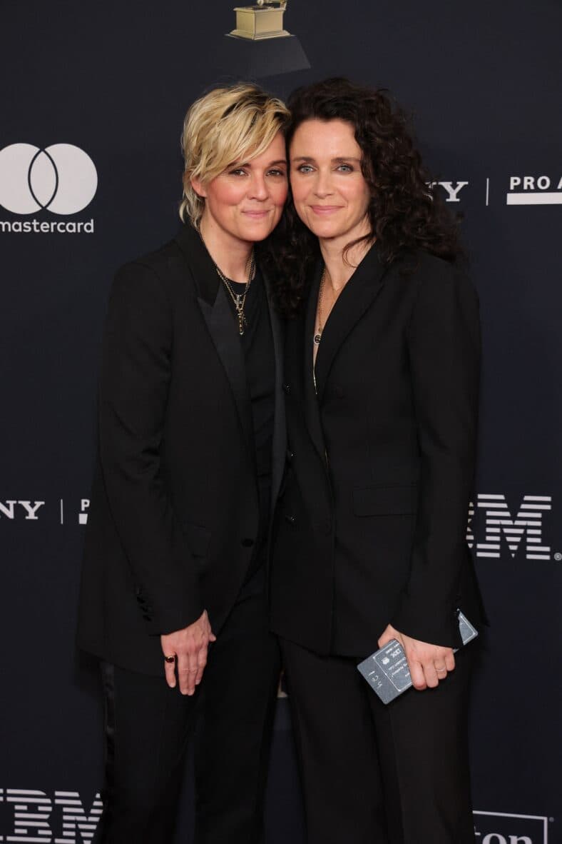 Brandi Carlile posing with someone on the red carpet.