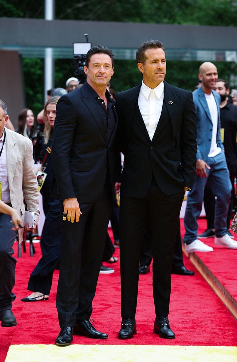 Hugh Jackman and Ryan Reynolds seen posing together alongside director Shawn Levy on the red carpet premiere for Deadpool and Wolverine tonight in New York City