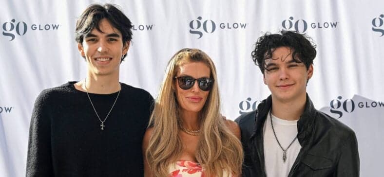 Brandi Glanville posing on the red carpet with her sons.