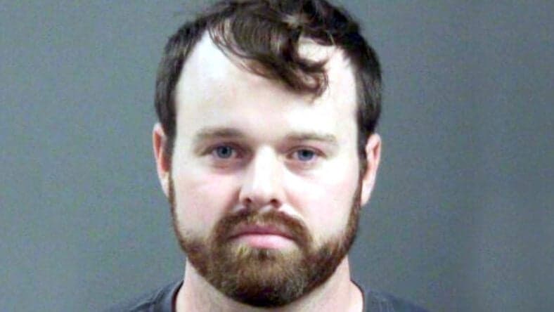 Joseph Duggar booking photo, a married father-of-four and the younger brother of convicted sex offender Josh Duggar was arrested on Wednesday in connection with allegations that he touched a nine-year-old girl on her underwear and genitals.