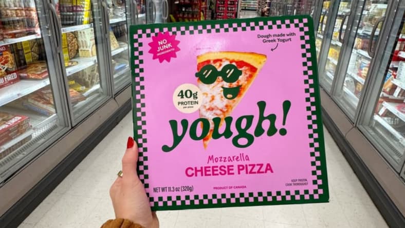 Someone holding up a box of Yough Pizza.