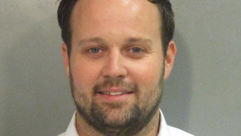 Josh Duggar smiles in new mugshot photograph after being found guilty in child pornography case
