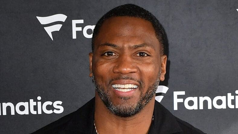 Ryan Clark posing on the red carpet.