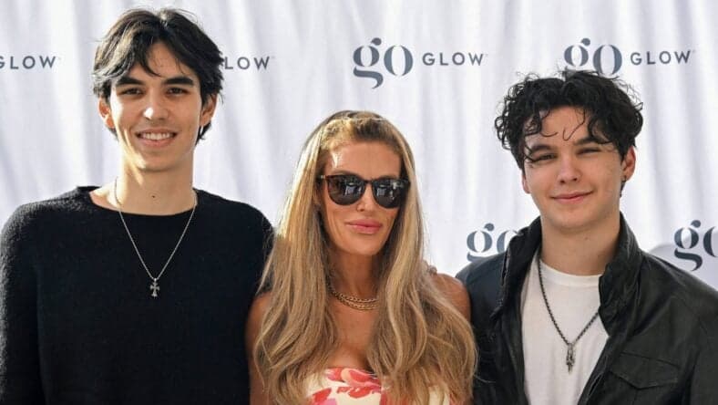 Brandi Glanville posing on the red carpet with her sons.