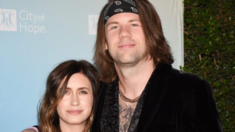 Caleb and Fleur Shomo posing on the red carpet.