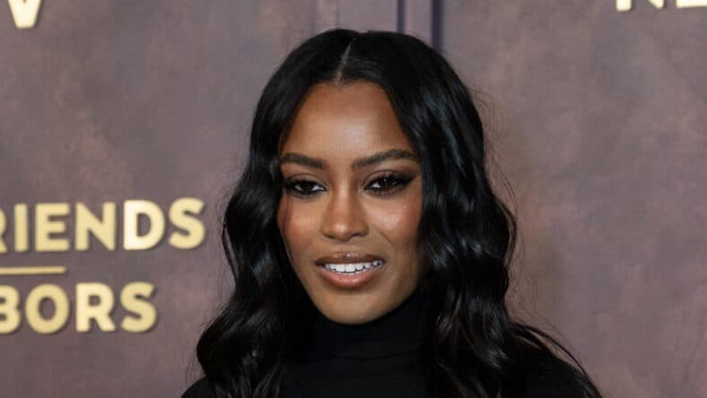 Ciara Miller posing on the red carpet.