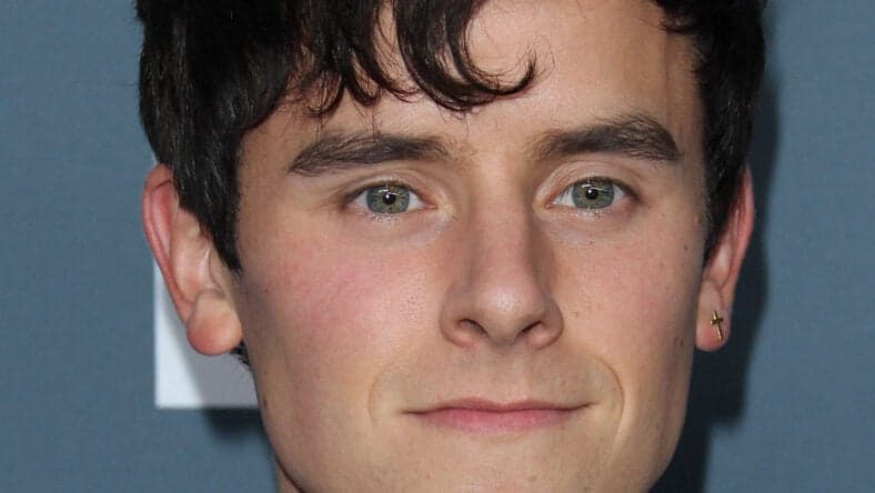 Connor Franta posing on the red carpet.