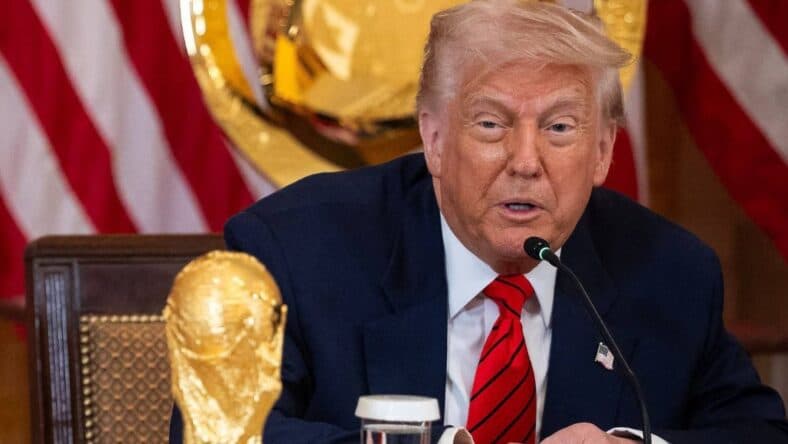 Donald Trump poses with the World Cup trophy