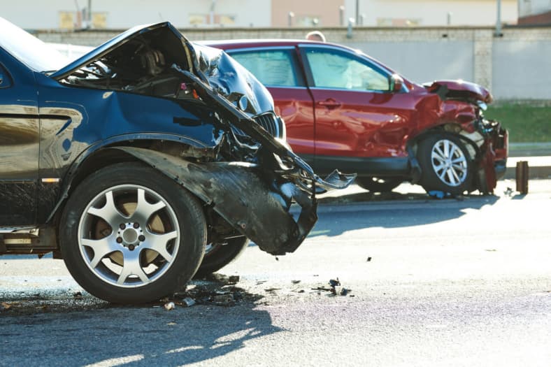Photo of two cars with their frontends smashed in.
