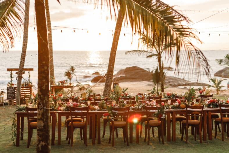 Table decorated for a wedding in a tropical setting.