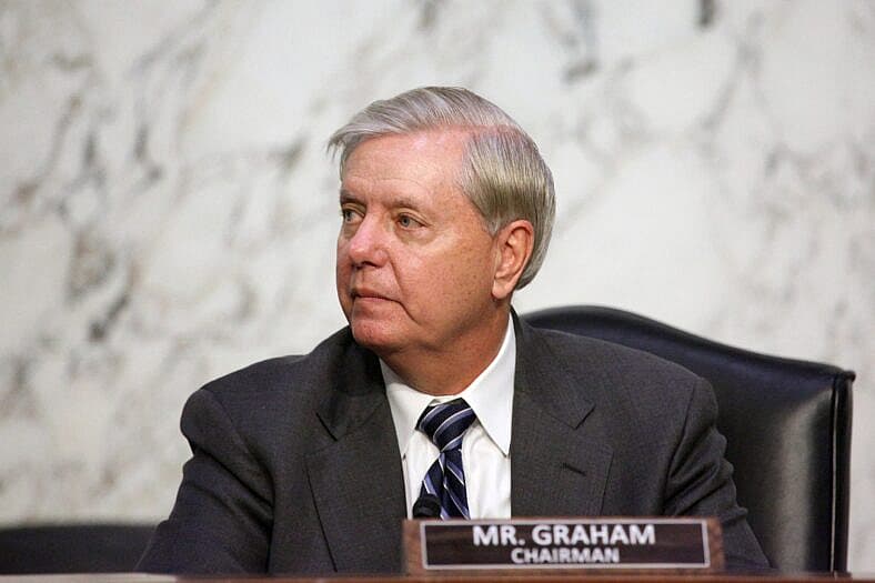 United States Senator Lindsey Graham (Republican of South Carolina) listens as Loretta Lynch, United States Attorney For The Eastern District Of New York,