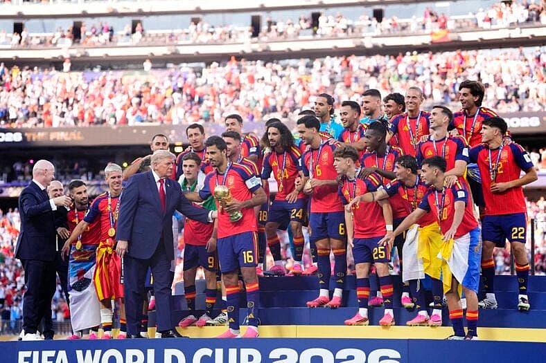 Donald Trump alongside Rodri Hernandez of Spain as team celebrates with the trophy after winning the 2026 FIFA World Cup