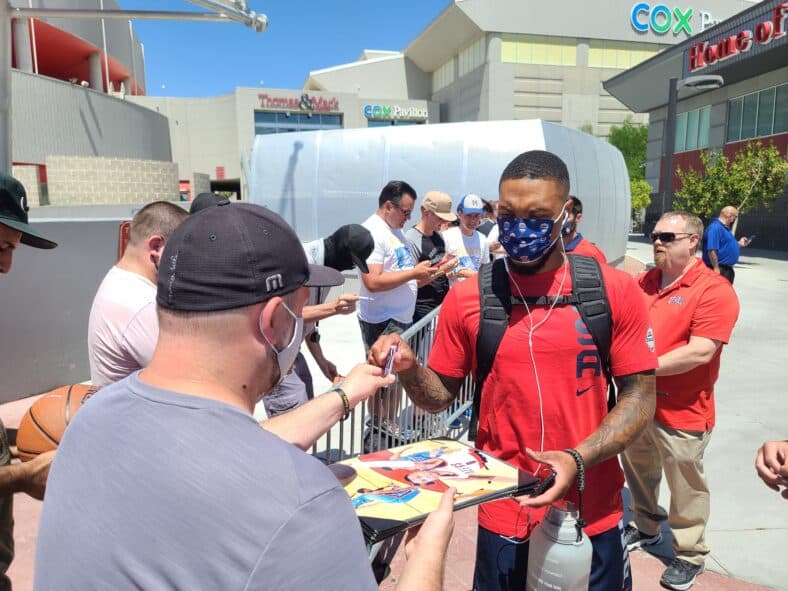 NBA superstar Damian Lillard wears USA mask as he hapily signs for his fans as he is ranked #2 player on Team USA basketball as he leaves the 1st practice with team in Las Vegas