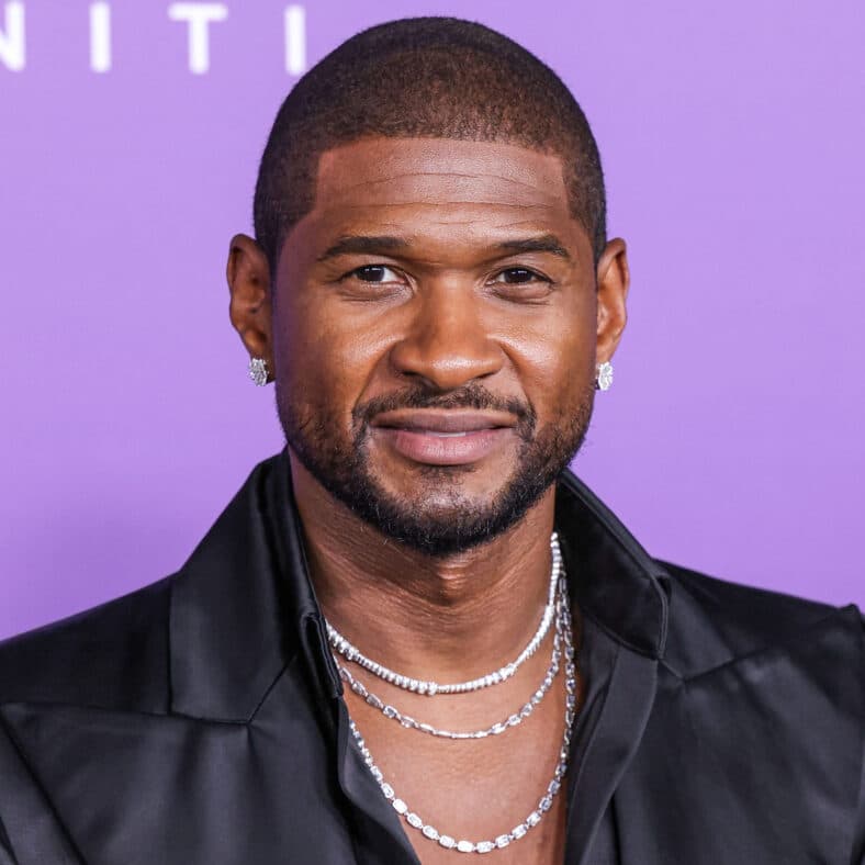 Usher posing on the red carpet.