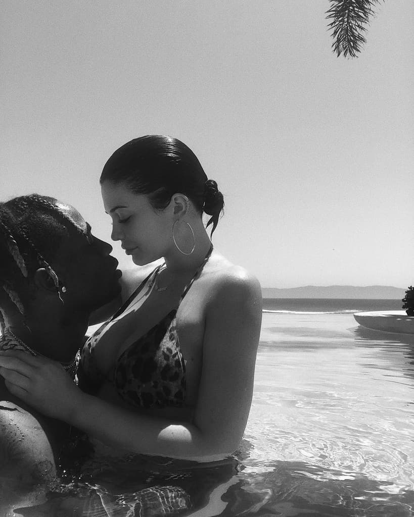 man and woman pose seductively in body of water