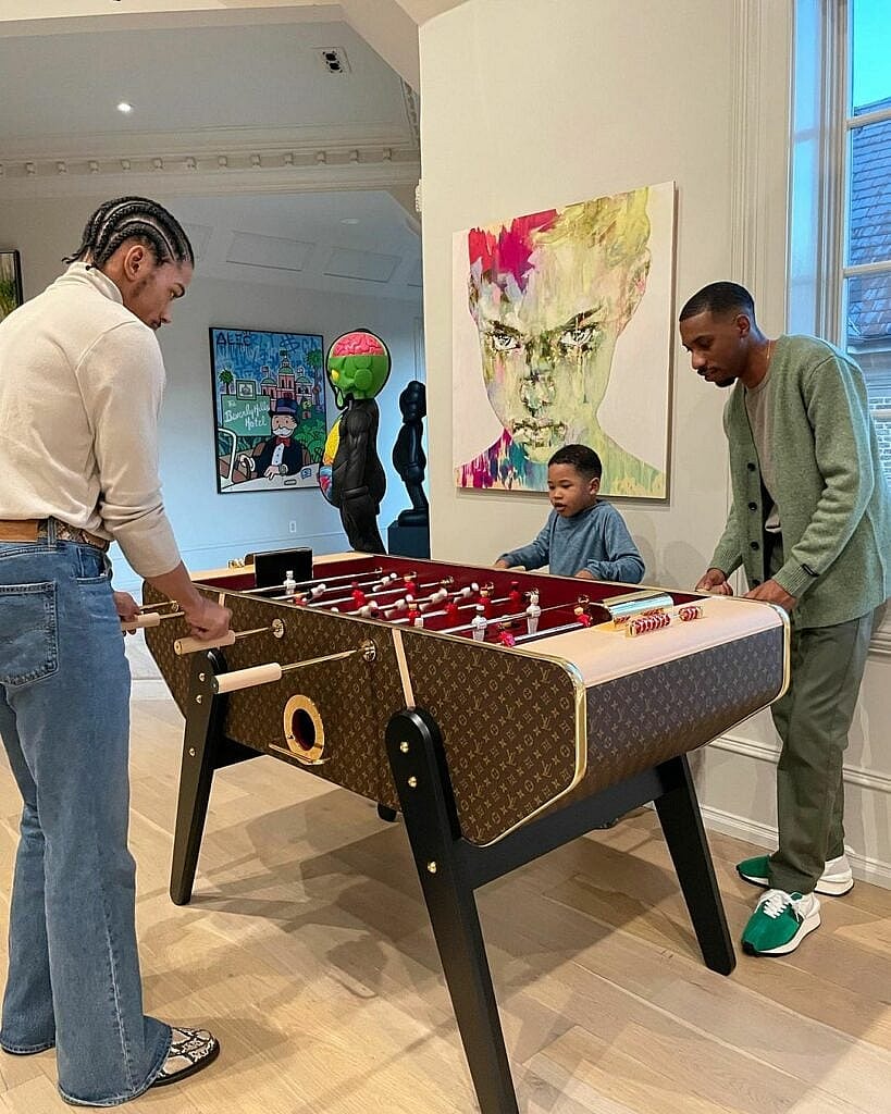 Broderick Harvey Jr. and Wynton Harvey playing foosball.