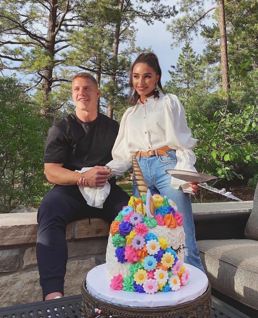 Olivia Culpo and Christian McCaffrey smiling.