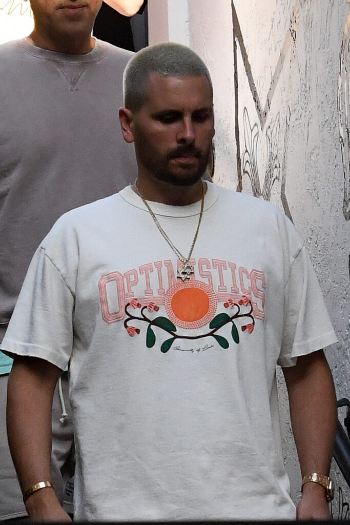 Scott Disick and girlfriend Amelia Hamlin admire the jewelry in the case as they peruse the Chrome Hearts showroom in the Miami Design District