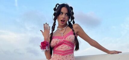 Olivia Rodrigo rolling her eyes in pink dress