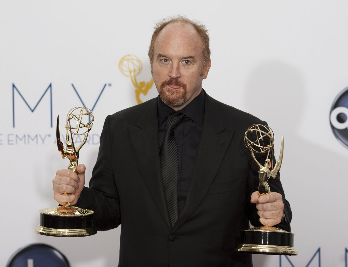 Louis C.K. holding two Emmy awards