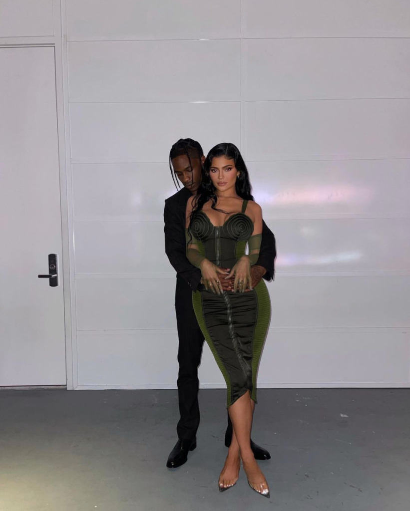 Travis Scott with his arms wrapped around Kylie Jenner