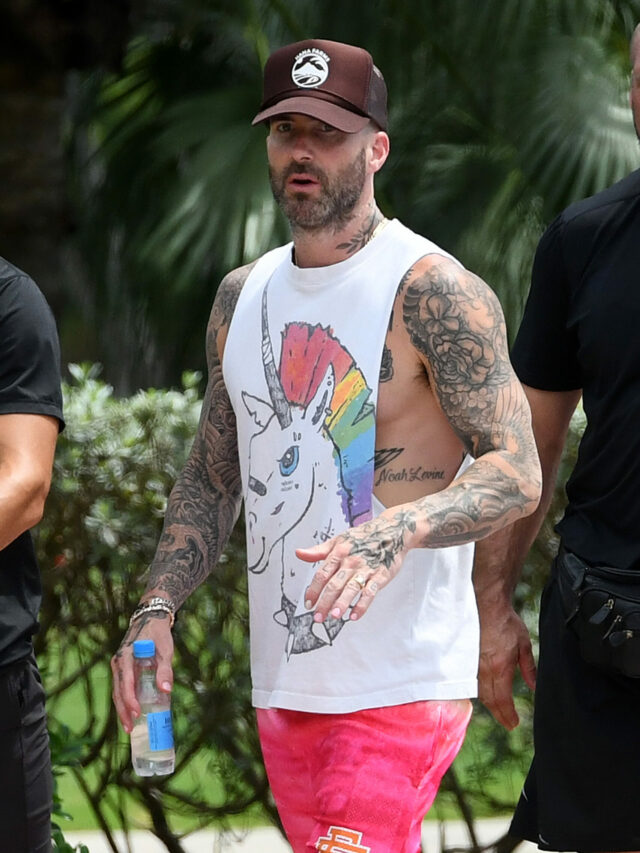 Adam Levine wears a unicorn shirt as he walks with his trainer and bodyguard in Miami