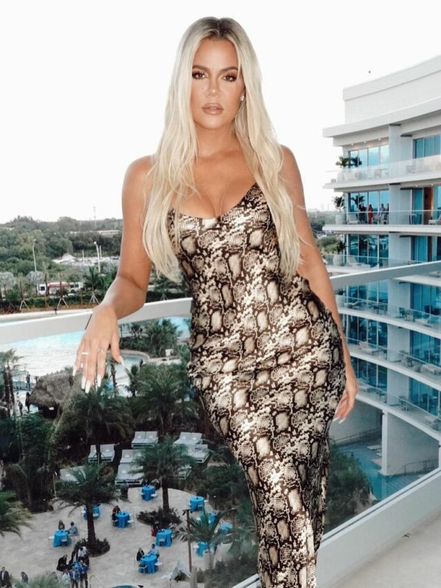 Khloe Kardashian leaning on a rail