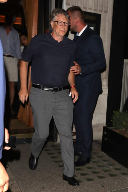 Microsoft Founder Bill Gates stumbles on a step as he leaves Jamavar in Mayfair after dining with friends