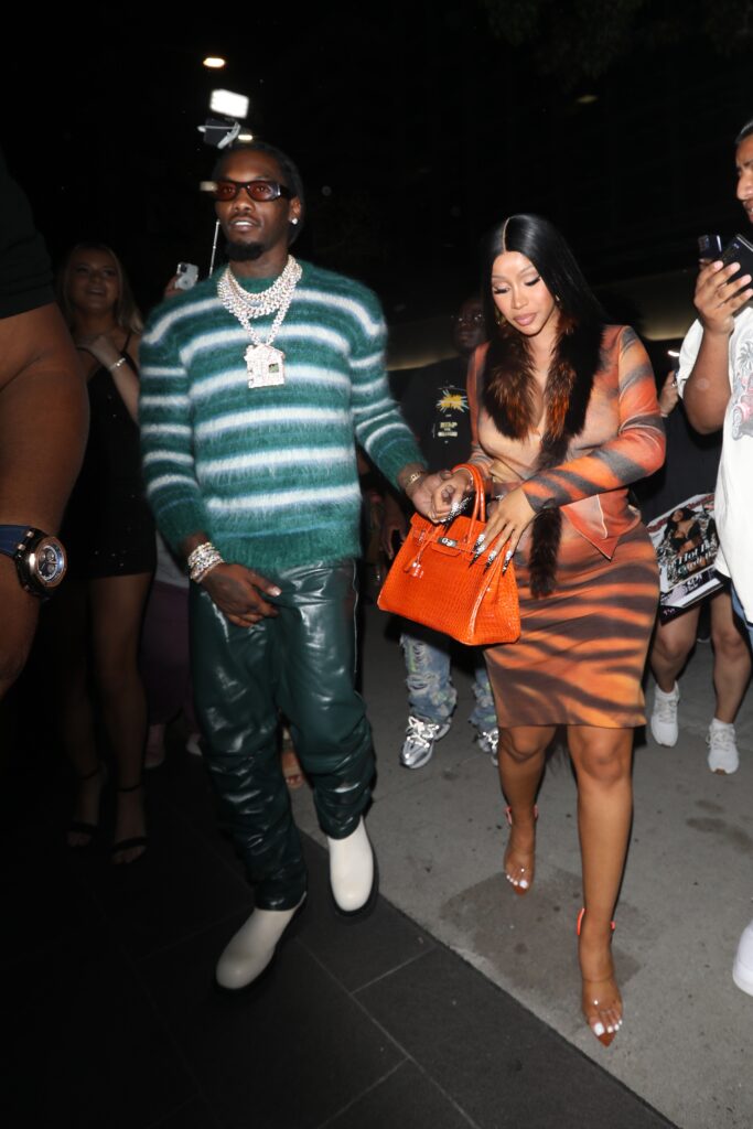 A pregnant Cardi B wears a leopard print dress as she and Offset head to BOA Steakhouse