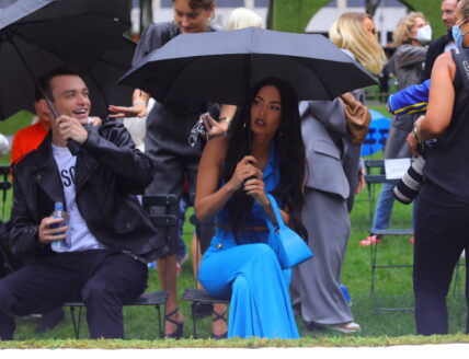Megan Fox stuns in blue as she stares into the cameras while holding an umbrella in the rain during the Moschino fashion show held outside during fashion week in NYC