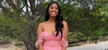 A photo showing Natalia Bryant in a pink off-shoulder dress, wearing a huge smile on her face