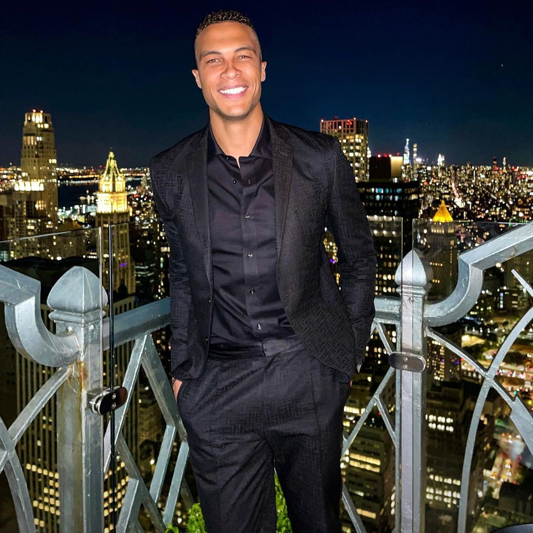 A photo showing Dale Moss in a black suit and inner T-shirt with a smile on his face.