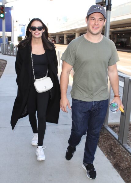 Adam devine and girlfriend Chloe Bridges arrive to LAX after trip to Hawaii
