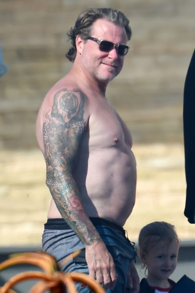 Tori Spelling slips into her swimsuit with Dean McDermott at a Mother apos s Day pool party at the beach with the family