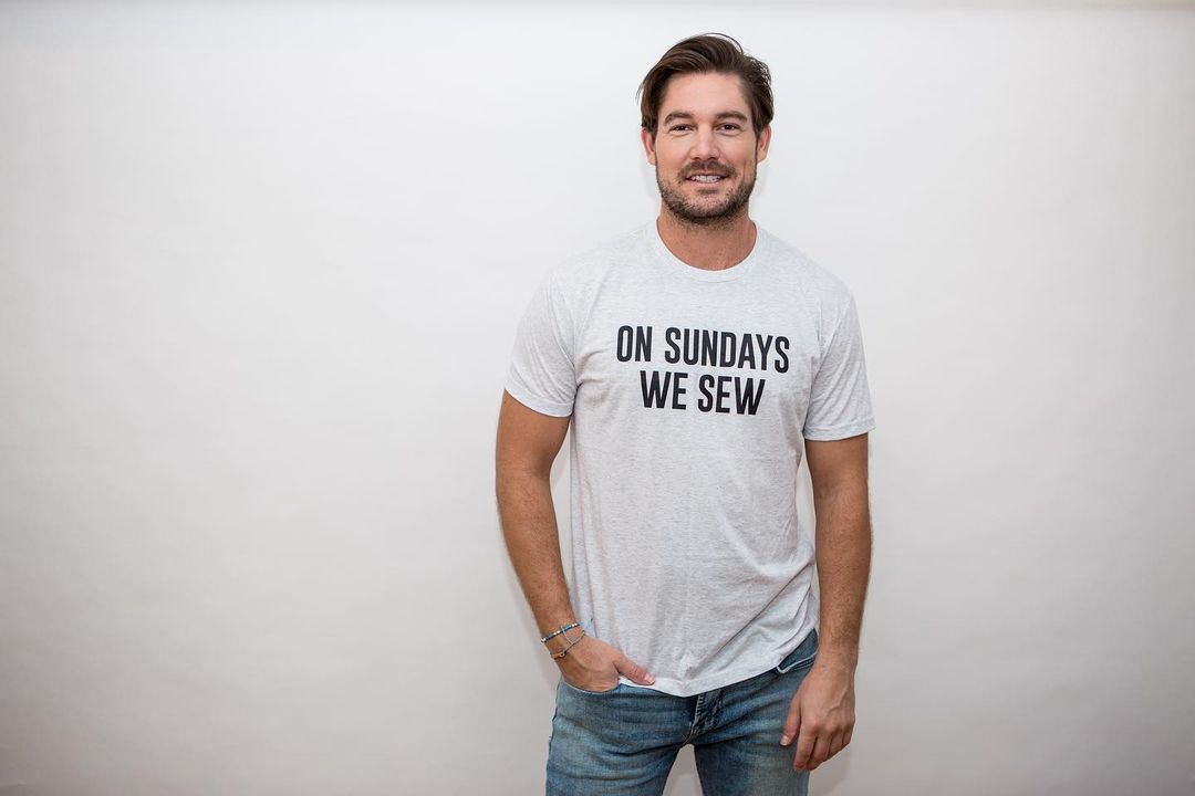 A photo showing Craig Conover in a white Tee and denim pant.