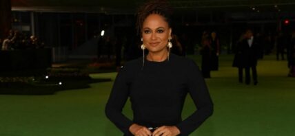 A photo showing Ava DuVernay in a black body-hug dress.