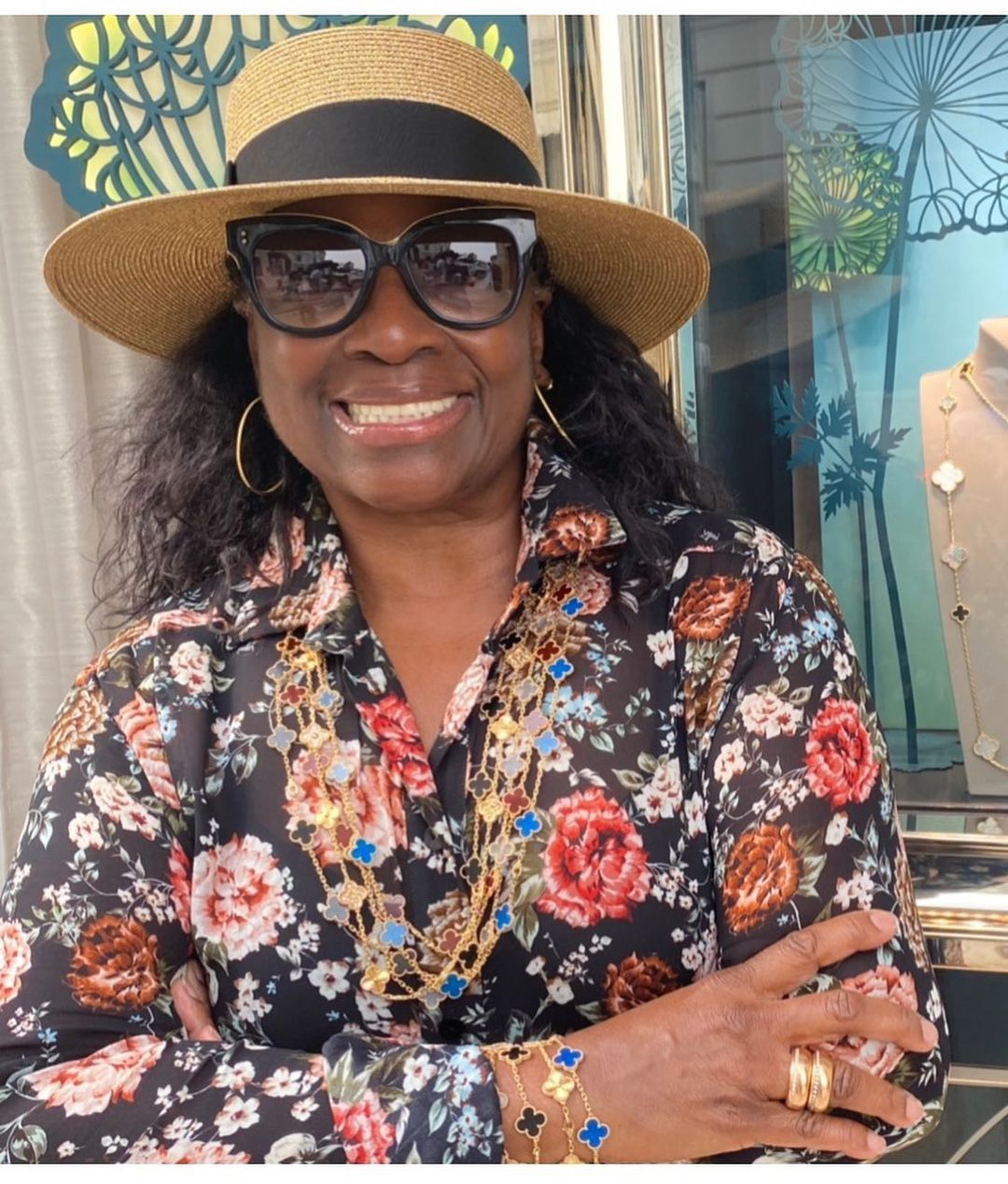 LaTanya Jackson sporting a multicolored blouse and brown hat.