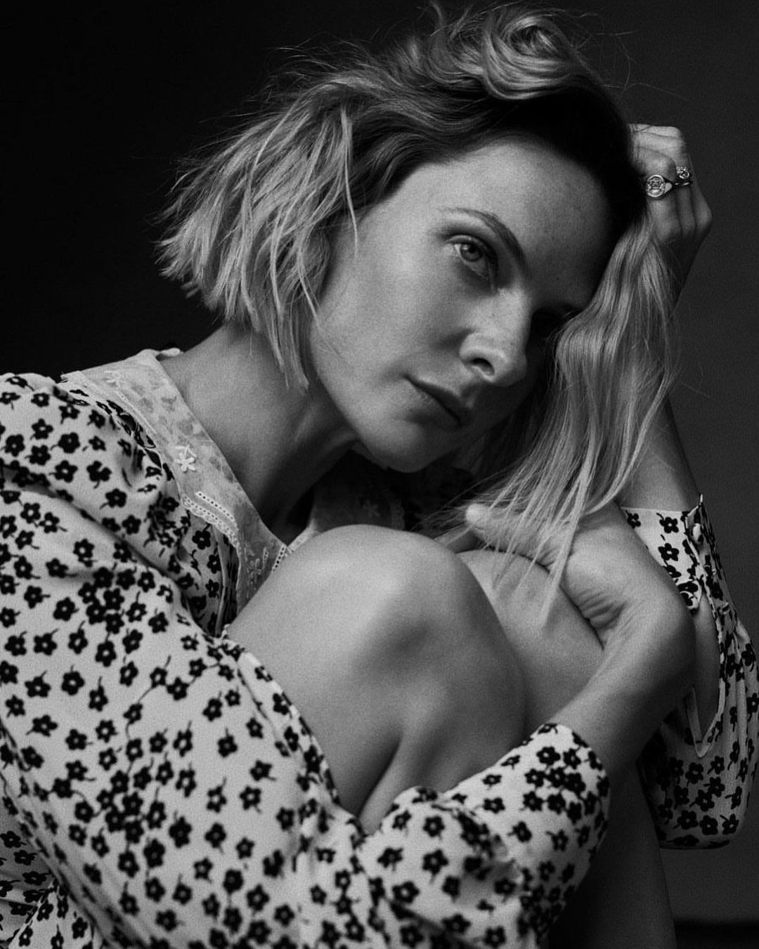 A black and white themed photo showing Rebecca Ferguson in a polka dot design outfit.