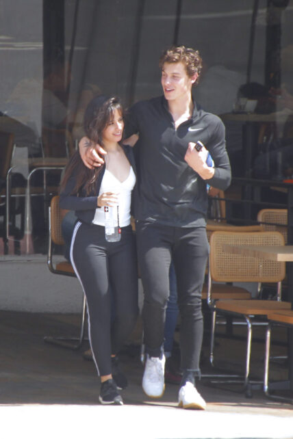 Shawn Mendes with arm around Camila Cabello