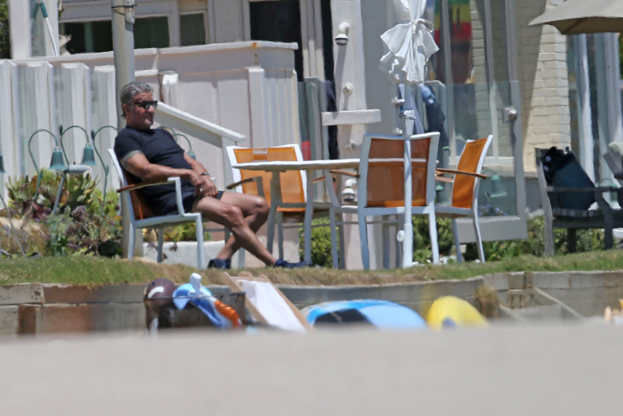Sylvester Stallone enjoys a cool drink while sitting by the beach in Malibu then takes a stroll on the beach with his daughter