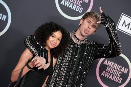 Machine Gun Kelly and daughter pose for the camera.